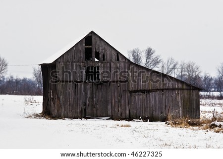 An old hay barn on a snowy overcast winter day