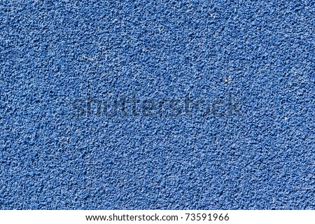 Blue tartan athletic running track texture on the stadium. Tartan track material is the trademarked all-weather synthetic track surfacing for athletics made of polyurethane