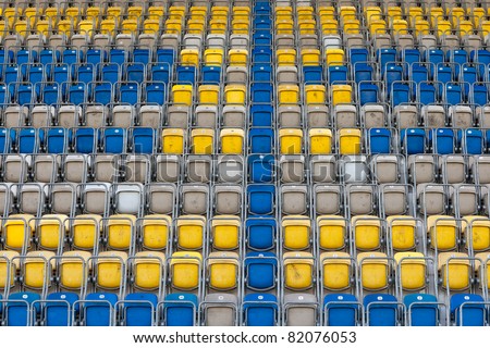 Colored stadium chairs. A field of empty stadium seats.