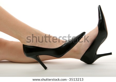 Bare legs in black high heels.  Isolated on white.