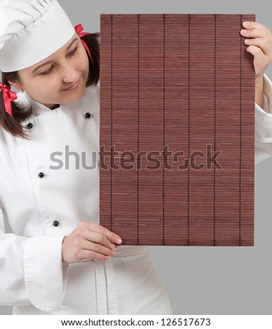 Woman chef holding a rack for dishes