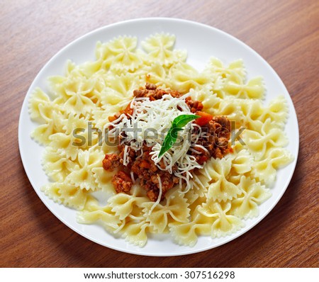Pasta with meat cheese and garnish with mint.