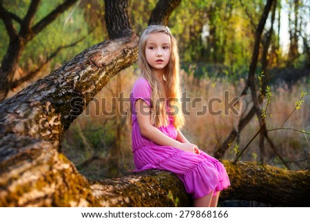 Lonely sad scared toddler girl in pink dress lost in forest try to find way back home