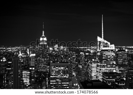 New York City skyline with urban skyscrapers at night, in black and white.