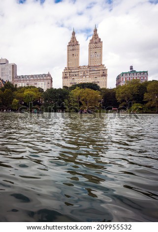 NEW YORK, NEW YORK, USA - OCT 13: Row boaters enjoy The Lake at Central Park on October 13, 2013.  Central Park is one of New York City\'s top attractions.