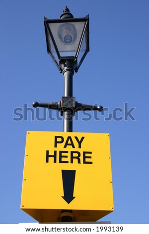 Car park pay here sign and old street lamp
