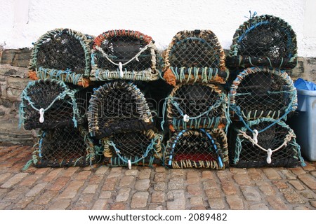 Lobster pots stacked at Mullion Cove, Cornwall, UK