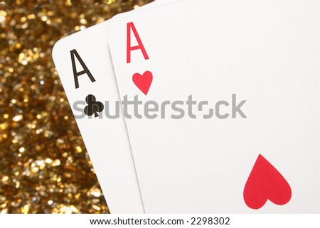 A pair of aces with a glittering gold background.