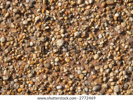 Close up of stones stuck to a wall.