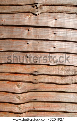 Close up of a wood slat fence.