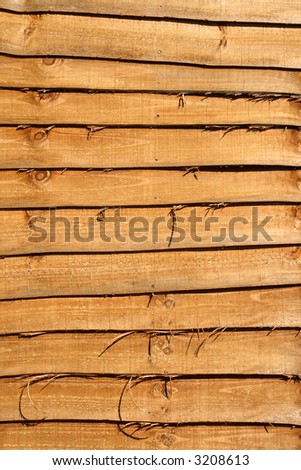 Orange fence wood slats close up.