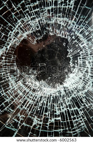 Close up of smashed glass in a shop window.