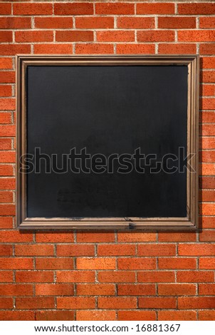 Blank old menu blackboard on a brick wall ready for text.