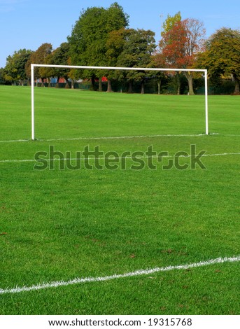 British football pitch goal posts in a park.