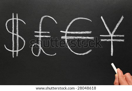Writing currency symbols on a blackboard.
