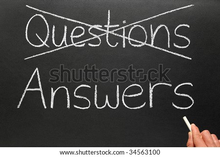 Crossing out questions and writing answers on a blackboard.
