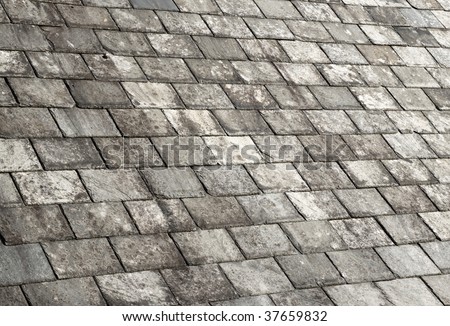 Old weathered gray slate tiles roof.
