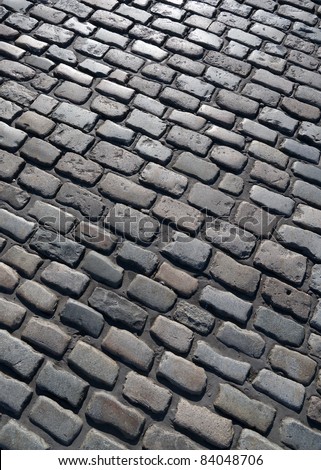Old English cobblestone road in Plymouth close up.