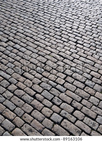 Old English cobblestones road in Plymouth close up.