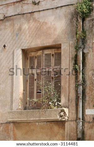 The almost broken window shutters of an old house