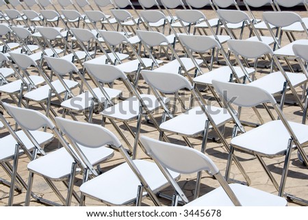 An array of white chairs waiting for the audience of an open-air event