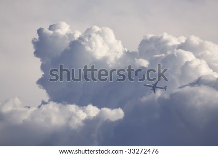 A passenger airplane passing in front of a cumulus storm cloud (digital combination of two photos)