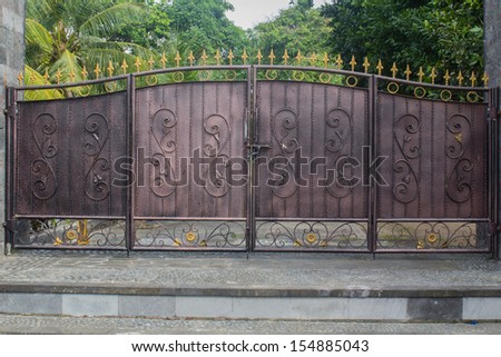 an old iron gate in front of a house in Bali