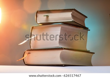 Three thick books on an abstract background with blurred lights. ストックフォト © 