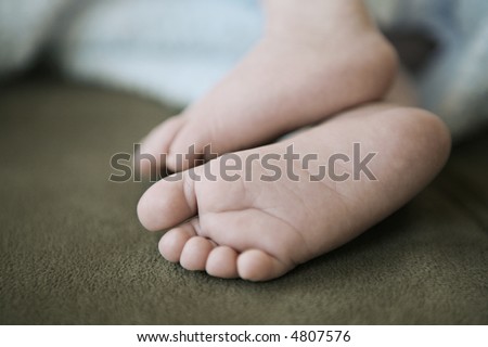 Baby Feet of 1-month-old baby.  Shallow depth-of-field.  Antique-style post processing.