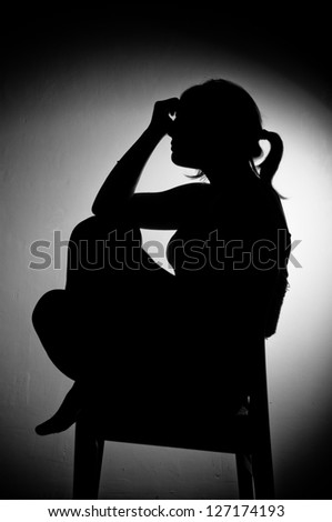sad woman sitting alone - black and white