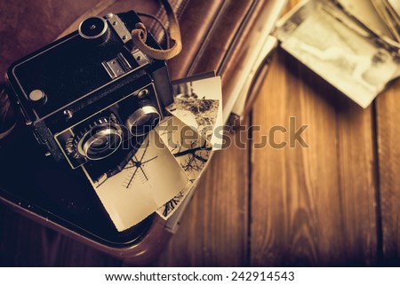 Old camera and old photos are on the case. Retouching in retro style