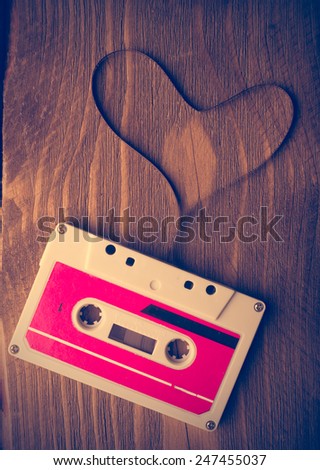 Audio cassette tape in the shape of heart. Retouching vintage.