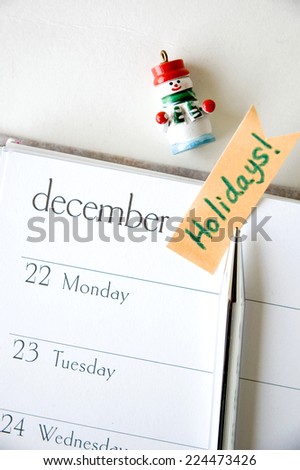 holidays sticky note on december planner