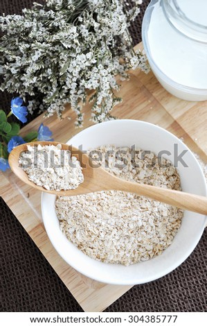 oat flakes on wooden spoon put on oat bowl