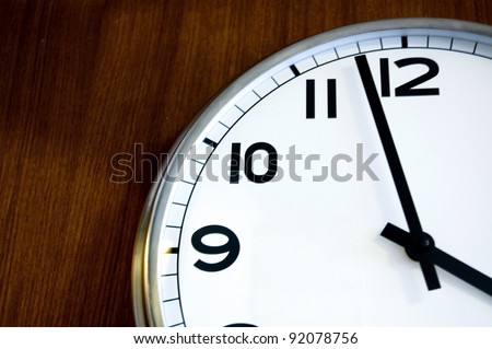 close up almost twelve on wall clock