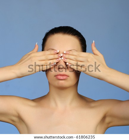 I see nothing. The woman closes eyes hands. A blue background