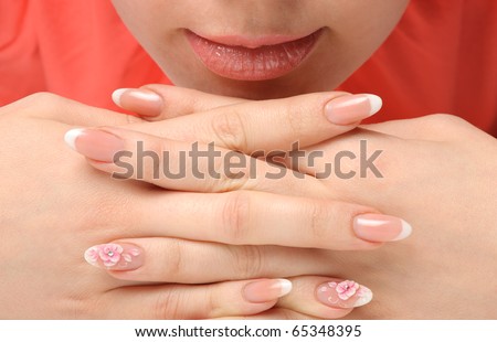 Manicure. Well-groomed female hands with a decorative element - a flower