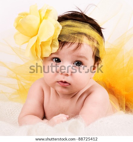 cute baby with yellow hair pin and flower