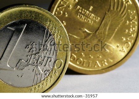One Euro and One Dollar coin. Euro is in front and in focus.