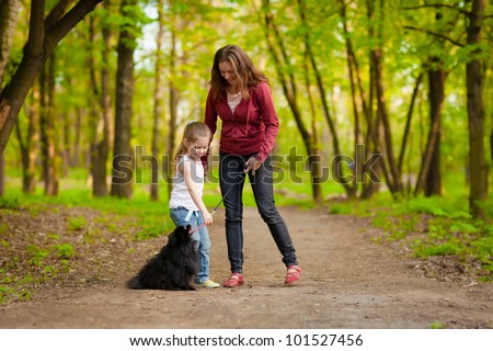 Mother and Daughter Walking the Dog