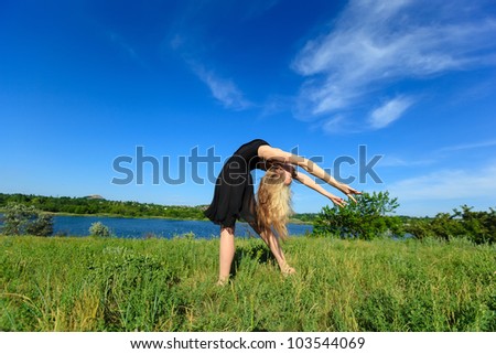 Young girl doing gymnastic outdoor, Blue sky background (1)