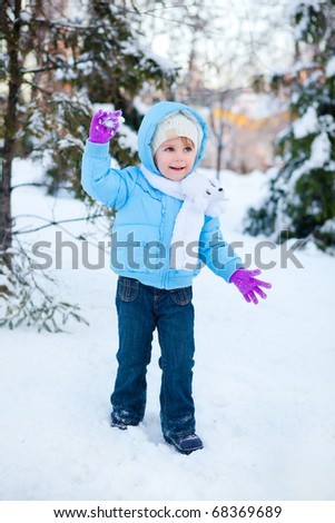 Winter joy - small kid playing with snow