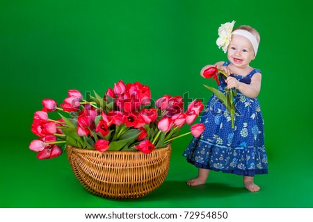 smiling sweet girl with  bouquet of tulips on green background