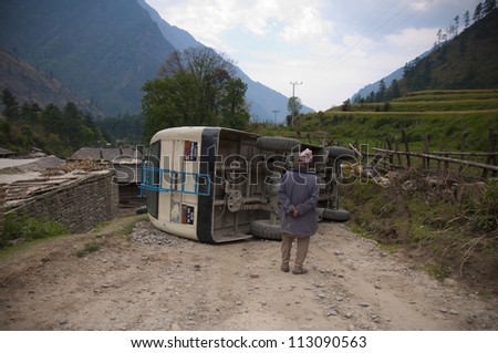 GHASA, NEPAL - APRIL 27:An unidentified nepali man watches bus crash in Ghasa in Nepal on 27 april 2012