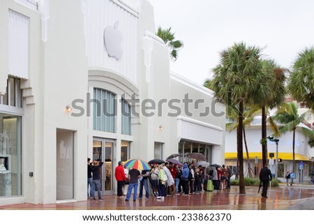 MIAMI BEACH - NOVEMBER 23: People waiting in line at the Apple Store at Lincoln Road Miami Beach on November 23, 2014 in Miami Beach USA. Apple is the worlds leading personal computer developer.