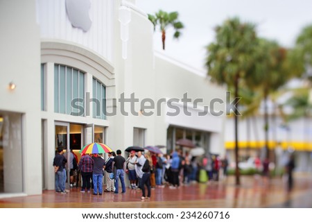 MIAMI BEACH - NOVEMBER 23: People waiting in line at the Apple Store at Lincoln Road Miami Beach on November 23, 2014 in Miami Beach USA. Apple is the worlds leading personal computer developer.