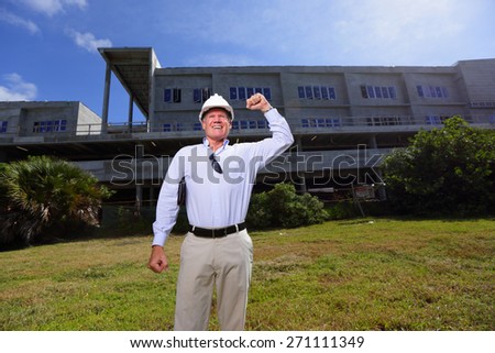 Stock image of a construction contractor pumping his fist in the air
