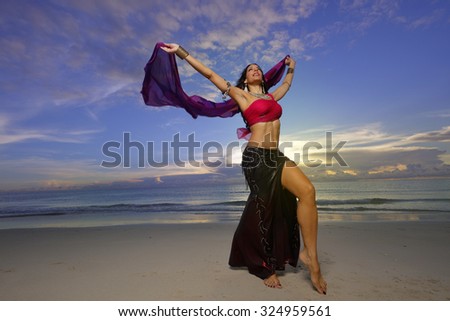 Belly dancing on the beach stock photo