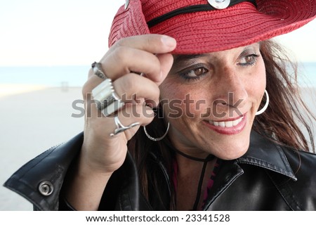 Woman tipping her hat and smiling