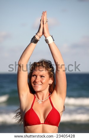 Woman clasping her hands above her head